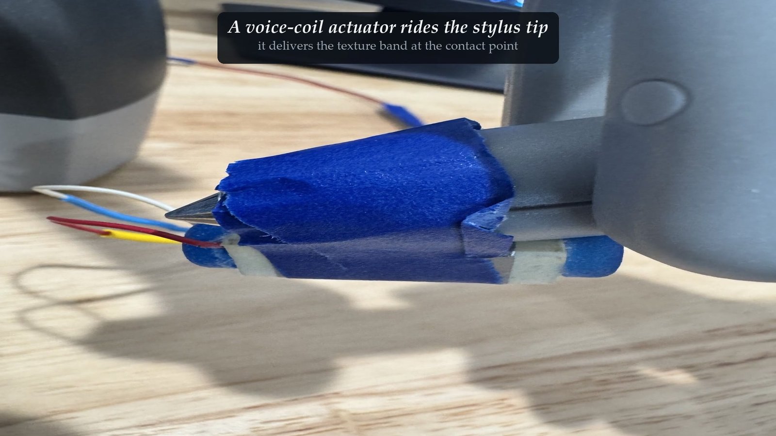A voice-coil actuator mounted at the tip of the force-feedback stylus